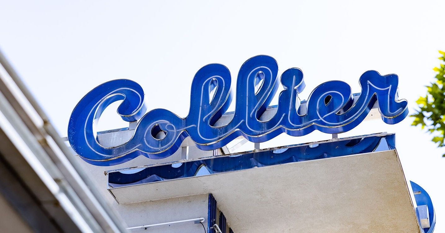 A blue sign that says collier on top of a building