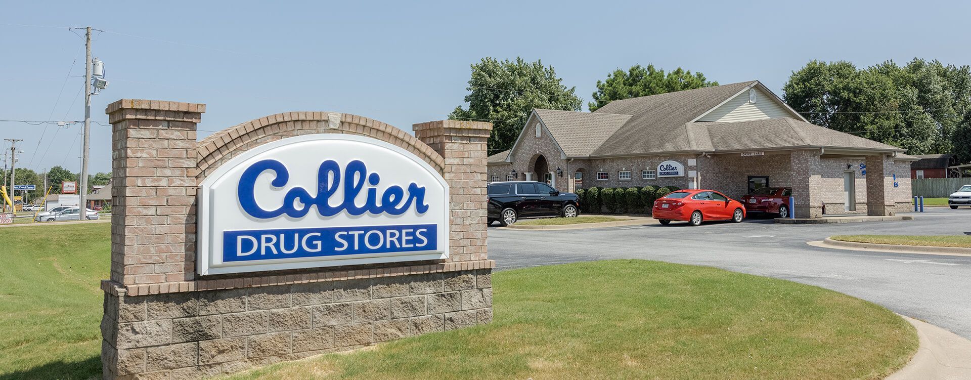 A sign for collier drug stores is in front of a building.