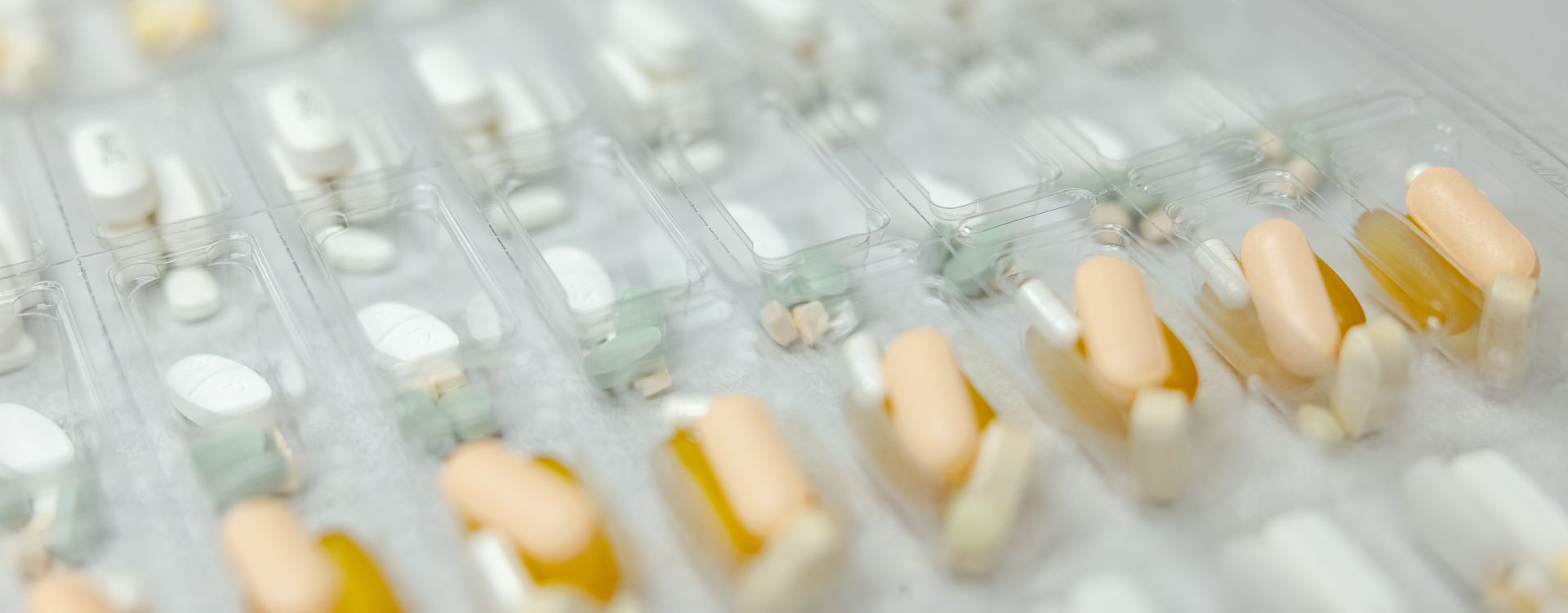 A close up of a tray of pills on a table.