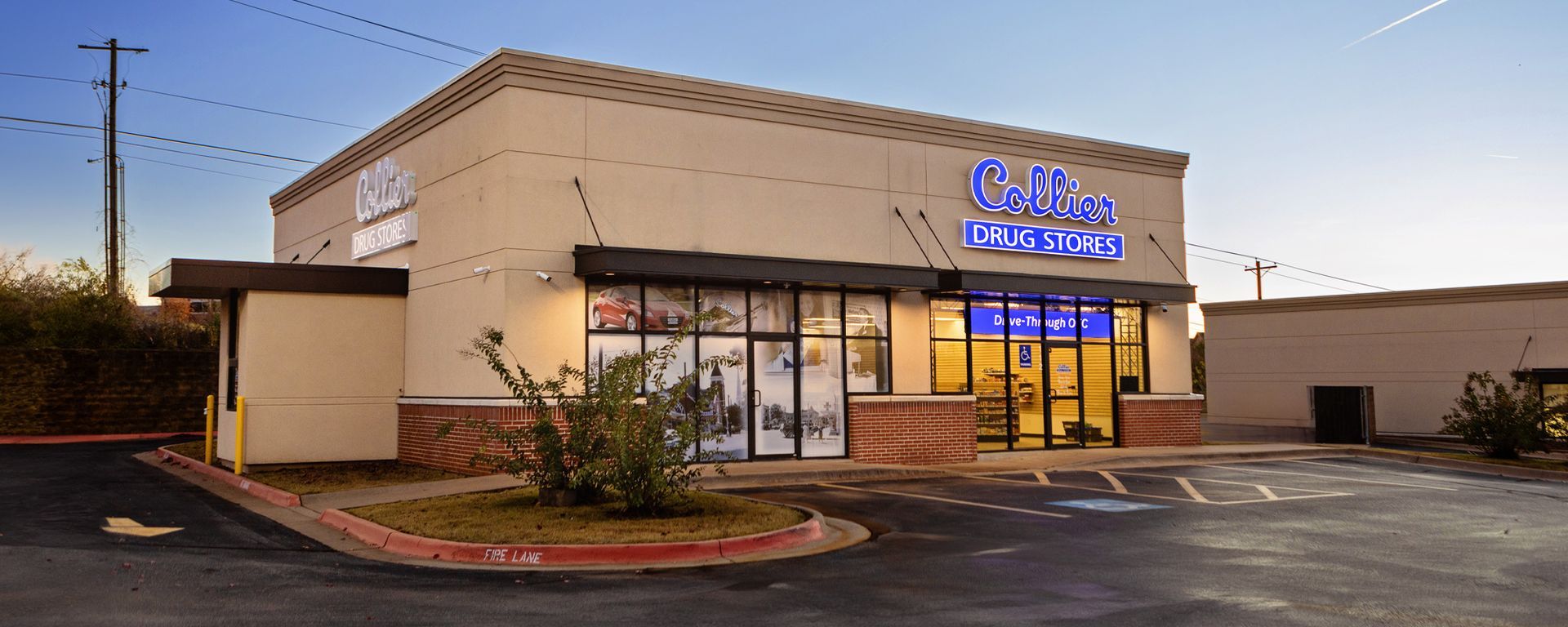 A large building with a lot of windows and a parking lot in front of it.
