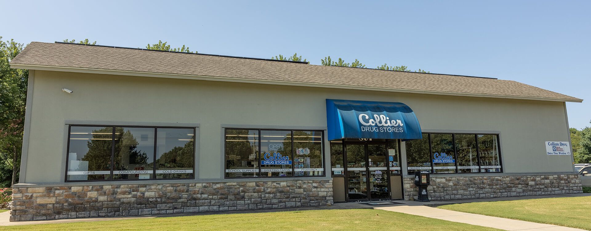 A large building with a blue awning and a lot of windows.