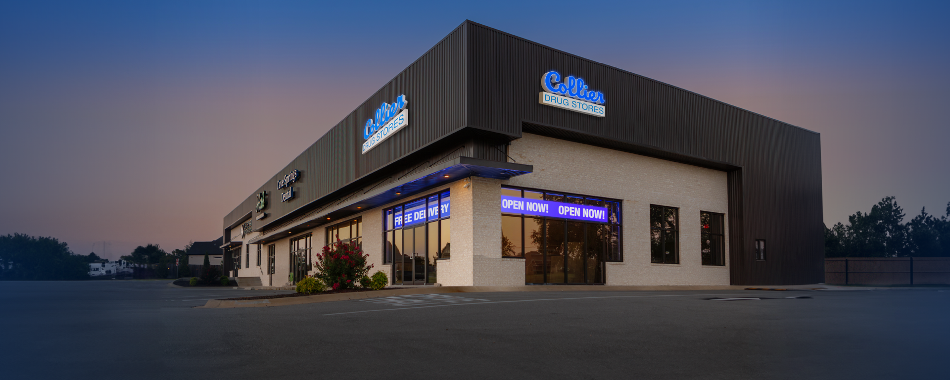 A large building with a lot of windows is lit up at night.