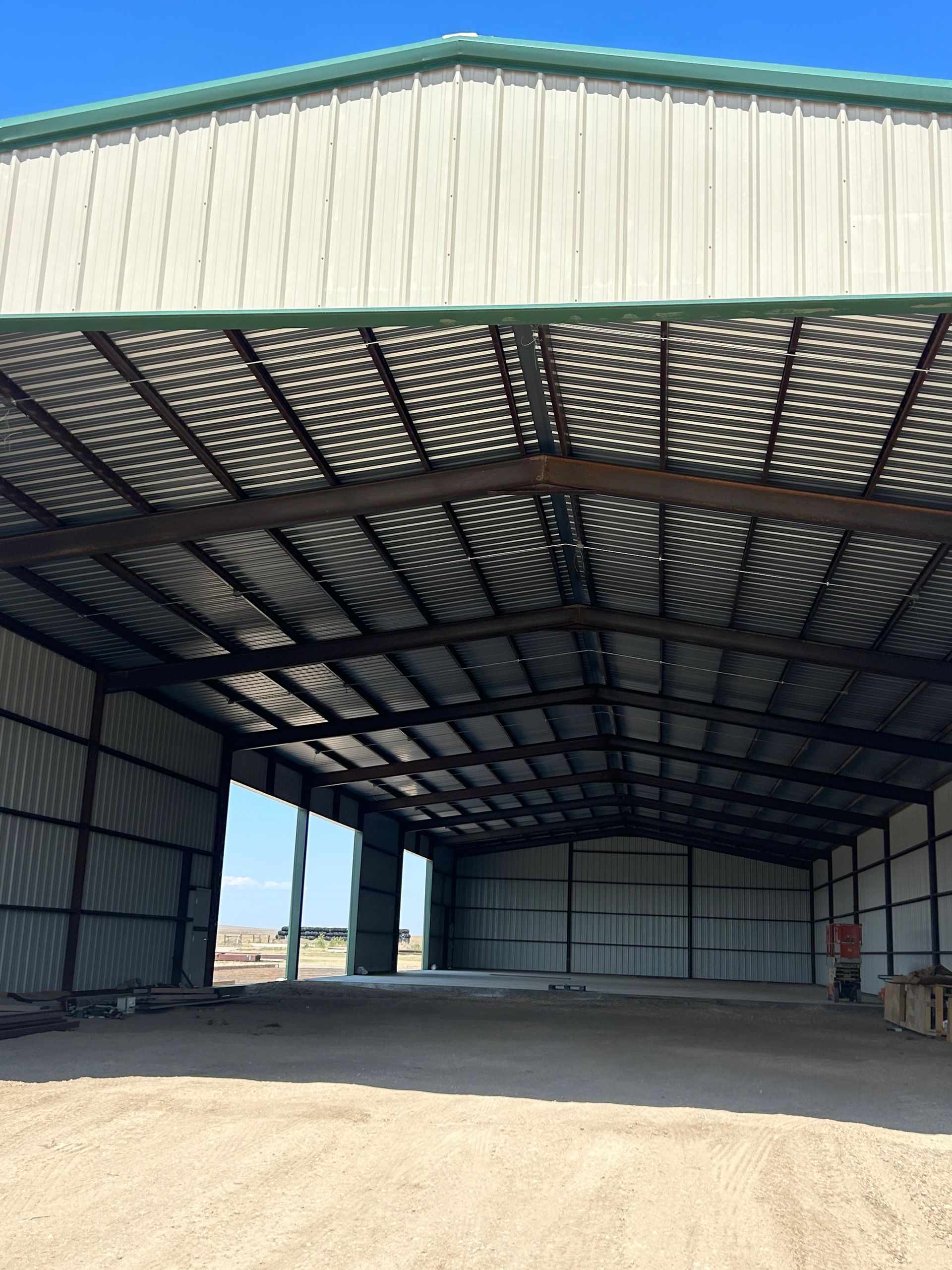 A large metal building with a green roof