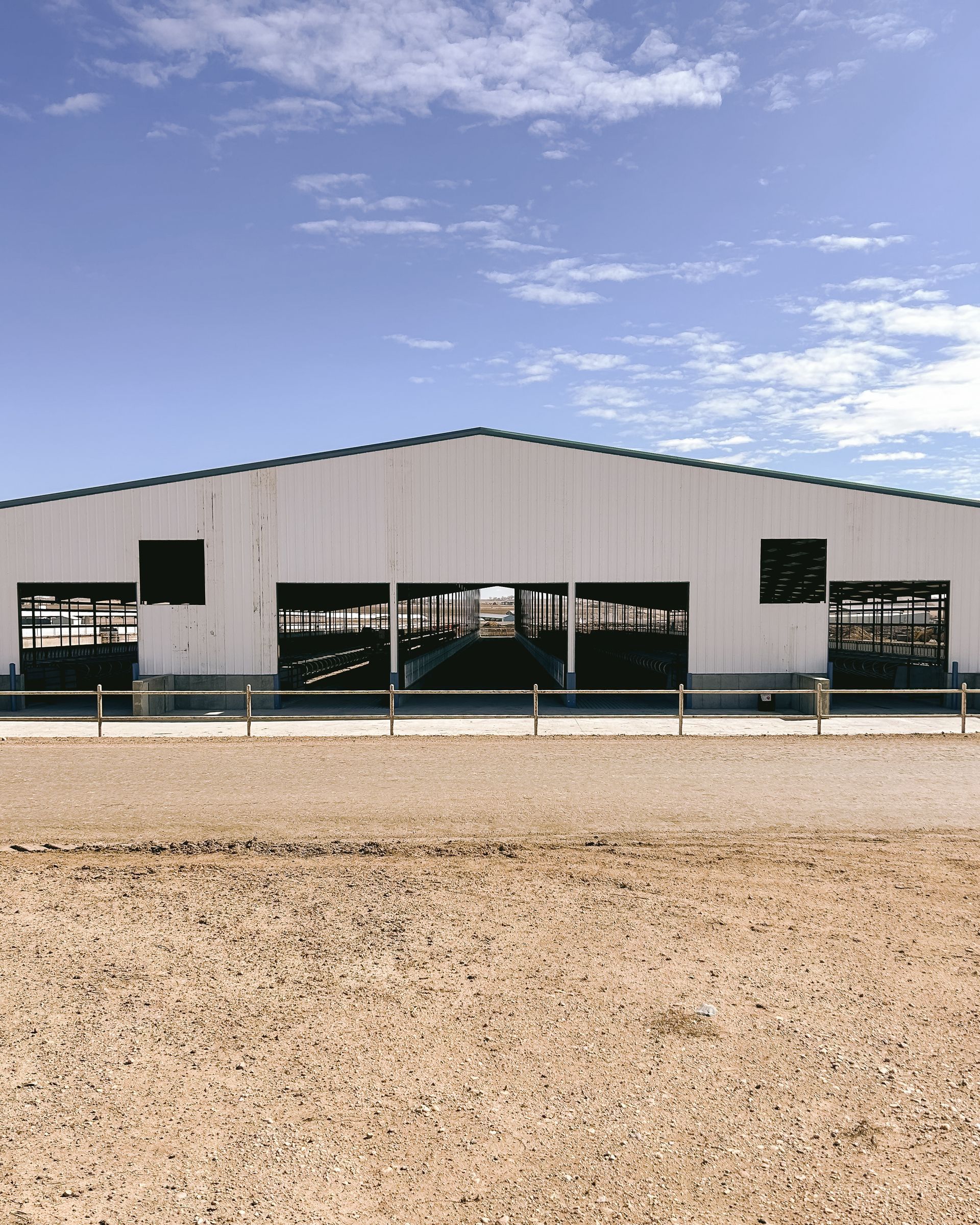 A large white building with a fence in front of it