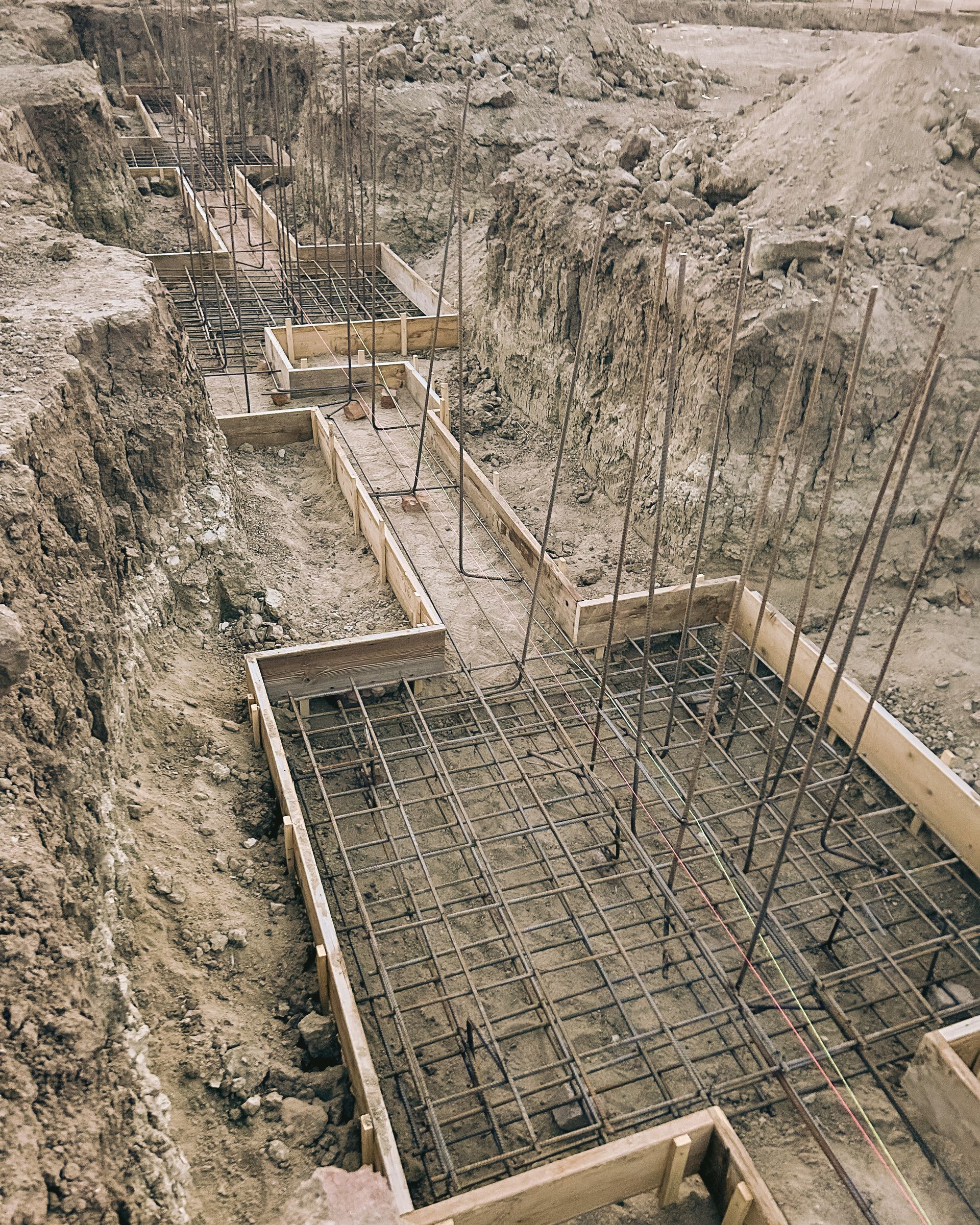 An aerial view of a construction site with a lot of dirt and concrete.