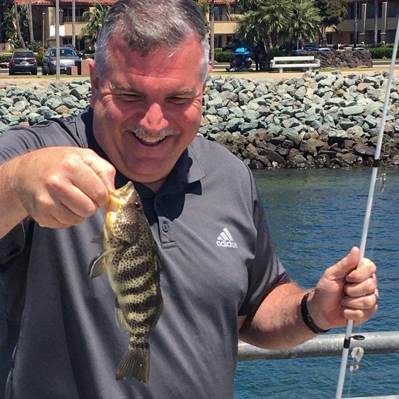 Happy Man Carrying a Fish — San Diego, CA — SoCal Eco Tours