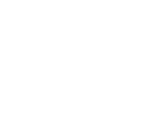 An industrial-style lamp with a dark metal dome shade and an exposed Edison-style bulb hanging from a ceiling.