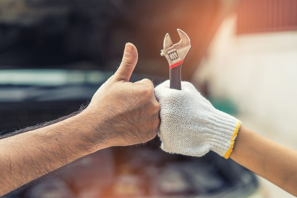 Hand of Mechanic With Thumbs Up and Tool — Mechanic in Tamworth, NSW