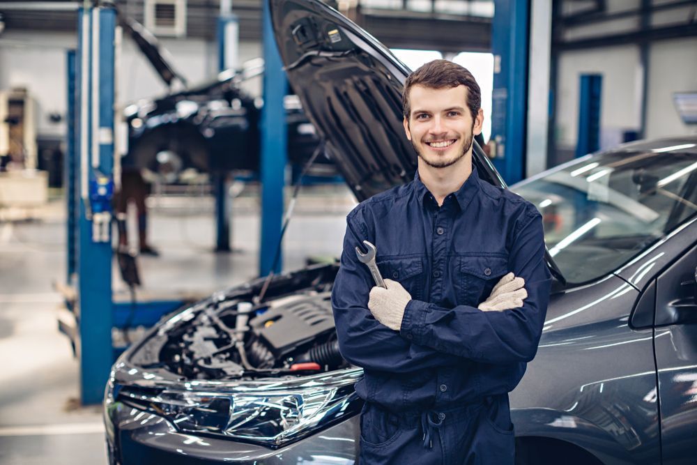 Happy Mechanic Standing by The Car — Mechanic in Tamworth, NSW