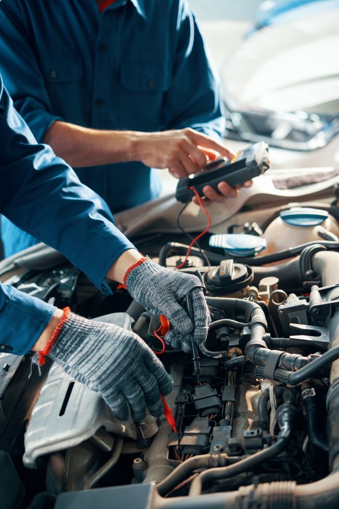 Hands of Professional Mechanics Using Professional Tool For Testing Car Motor — Mechanic in Tamworth, NSW