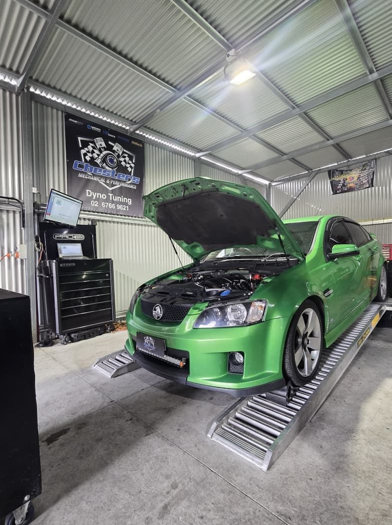 A Green Car is on a Dyno Testing Platform — Mechanic in Tamworth, NSW