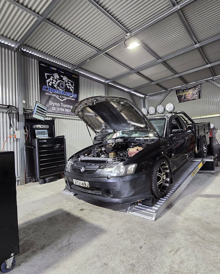 Car with Open Hood in Garage
