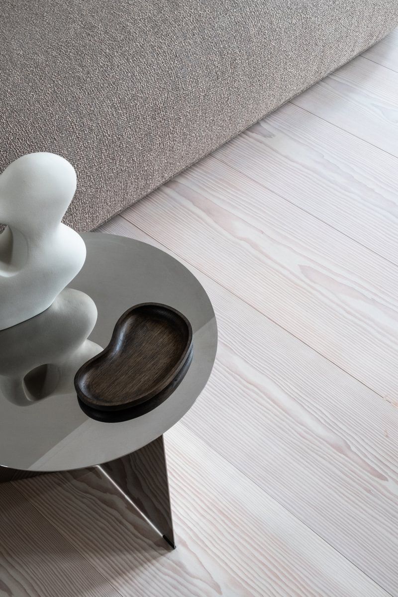 Et bord med en vase og en statue på i en stue.