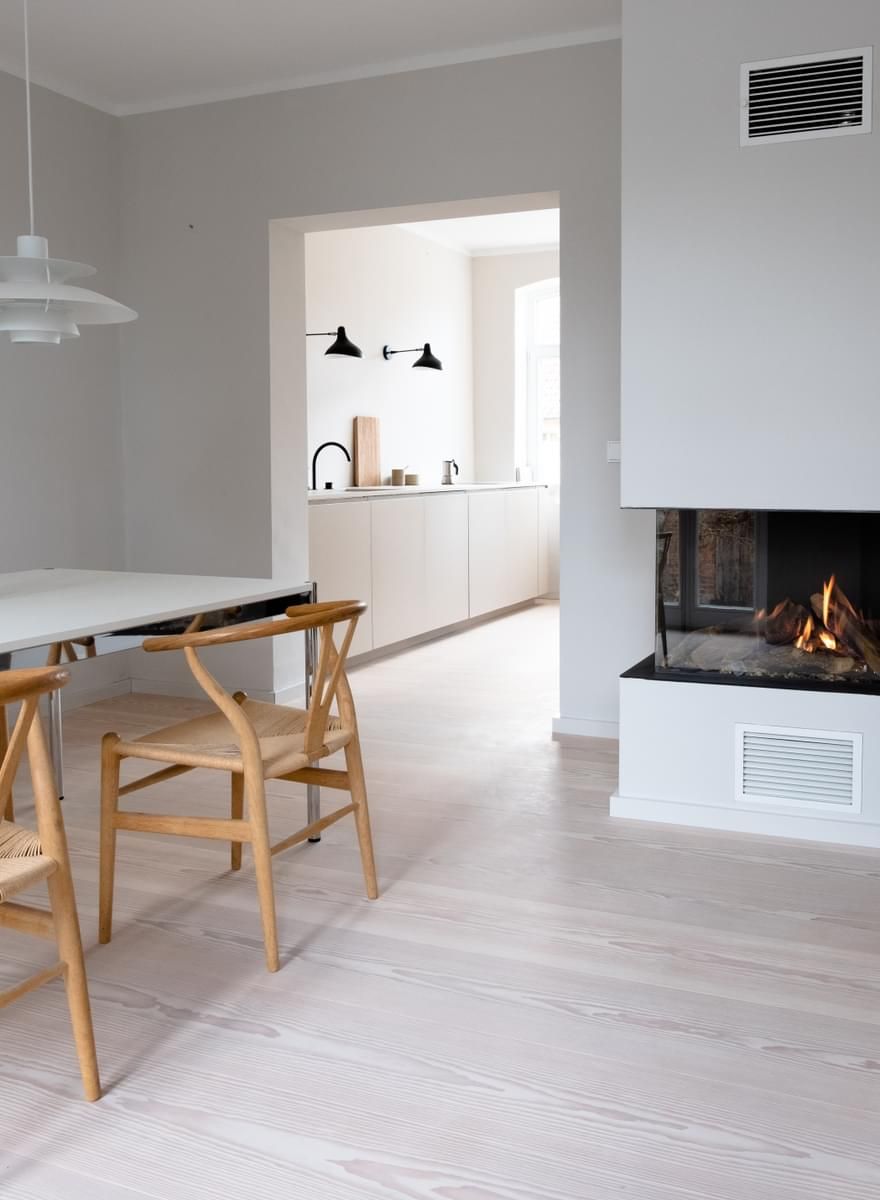 En spisestue med bord og stoler og peis