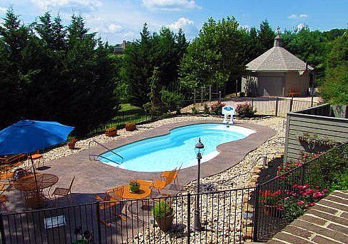 Fiberglass Pool With Table And Chairs — Staunton, VA — Valley Pool & Spa