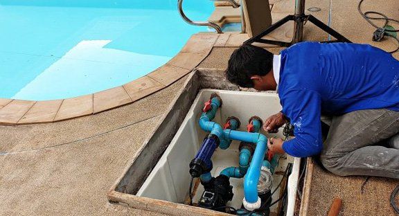 Man Cleaning Pool Pump — Staunton, VA — Valley Pool & Spa