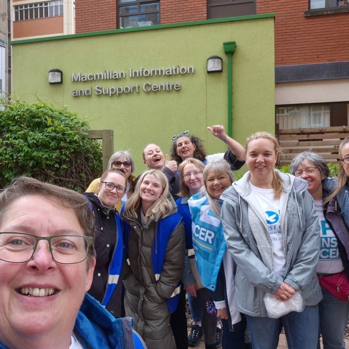 A group of people are posing for a picture in front of the maternity information and support centre