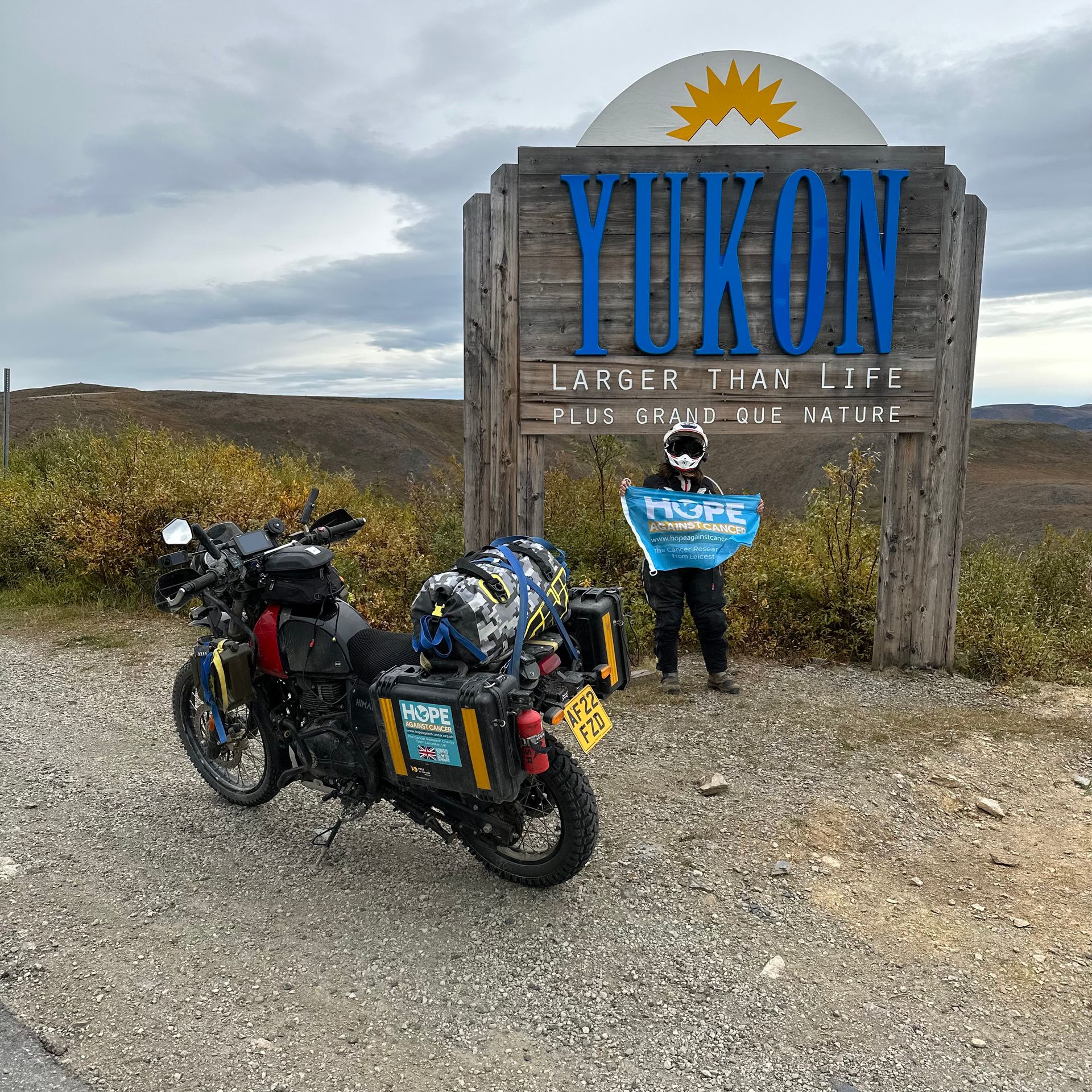 A motorcycle is parked in front of a yukon sign