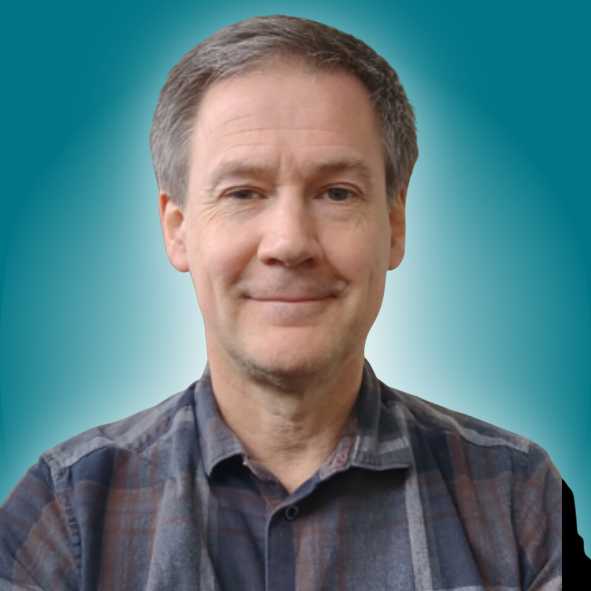 A man in a plaid shirt is smiling in front of a blue background