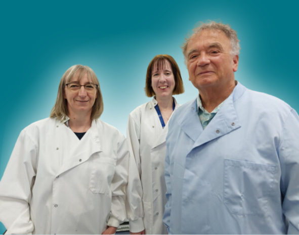 A man and two women standing next to each other in lab coats