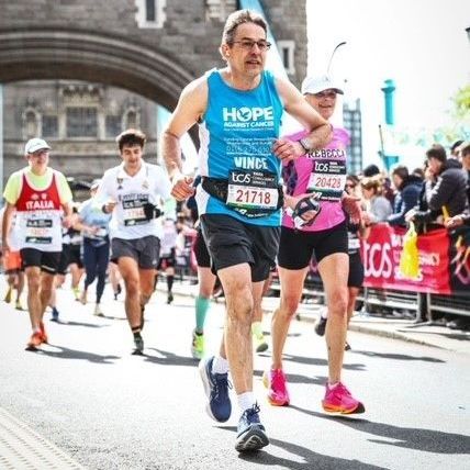 A man wearing a hope shirt is running a marathon