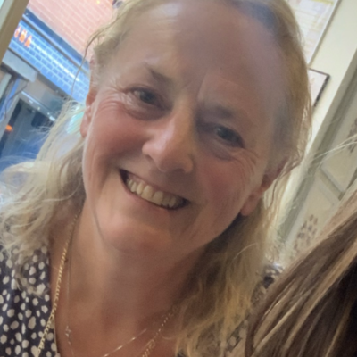 Photo of Hope Volunteer Ambassador Gill Merrill smiling into the camera