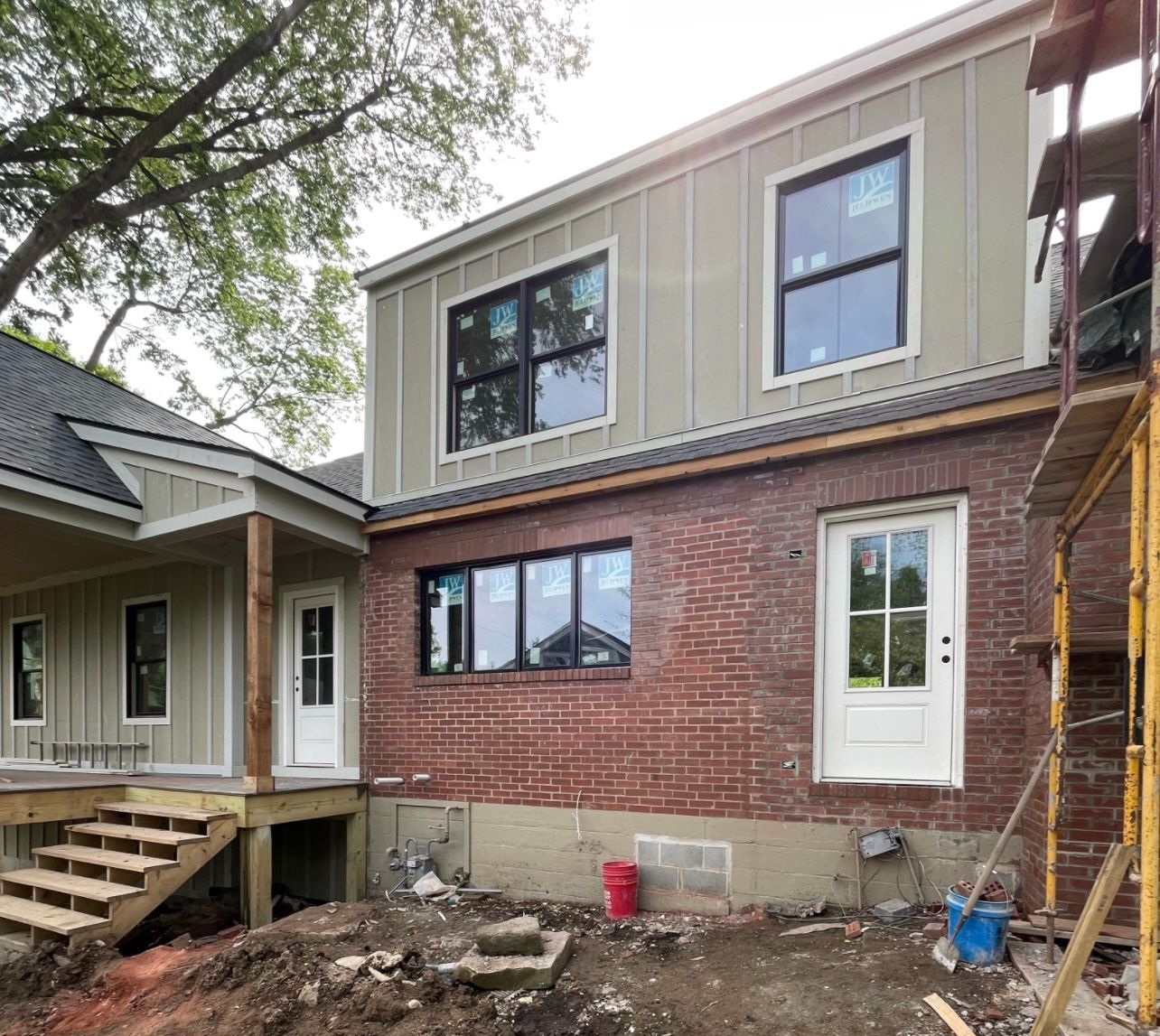 A house is being built with a lot of windows and bricks.