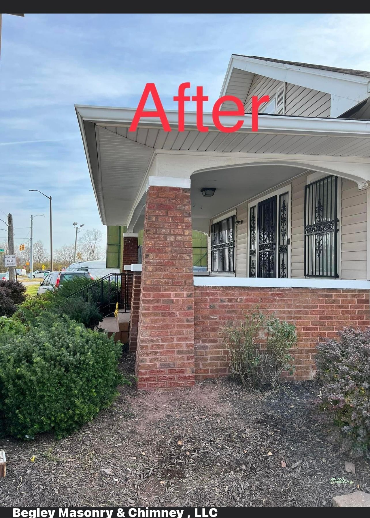 A picture of a house with a brick porch and a chimney.