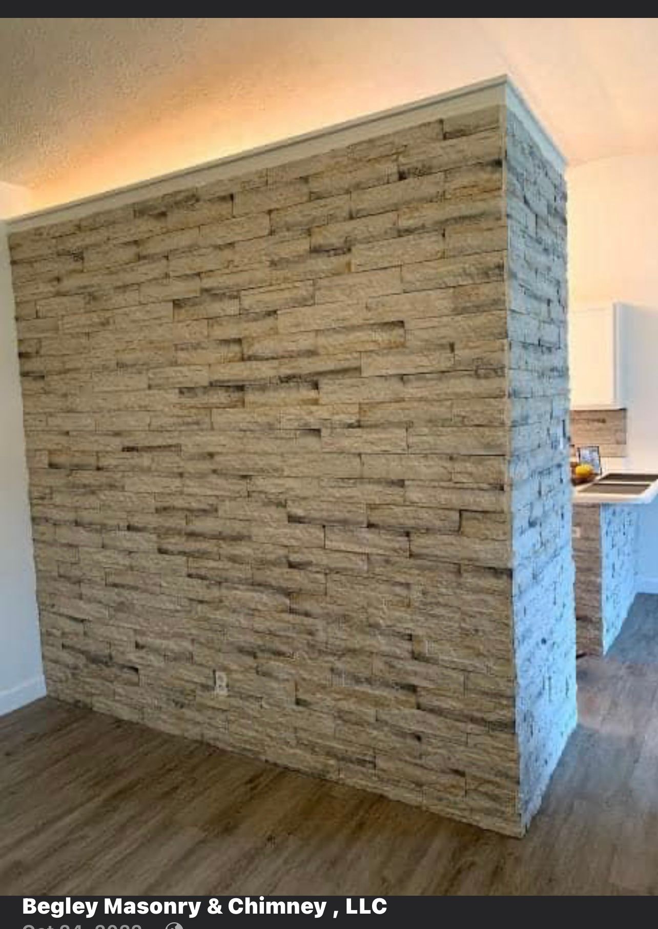 There is a brick wall in the middle of a room.