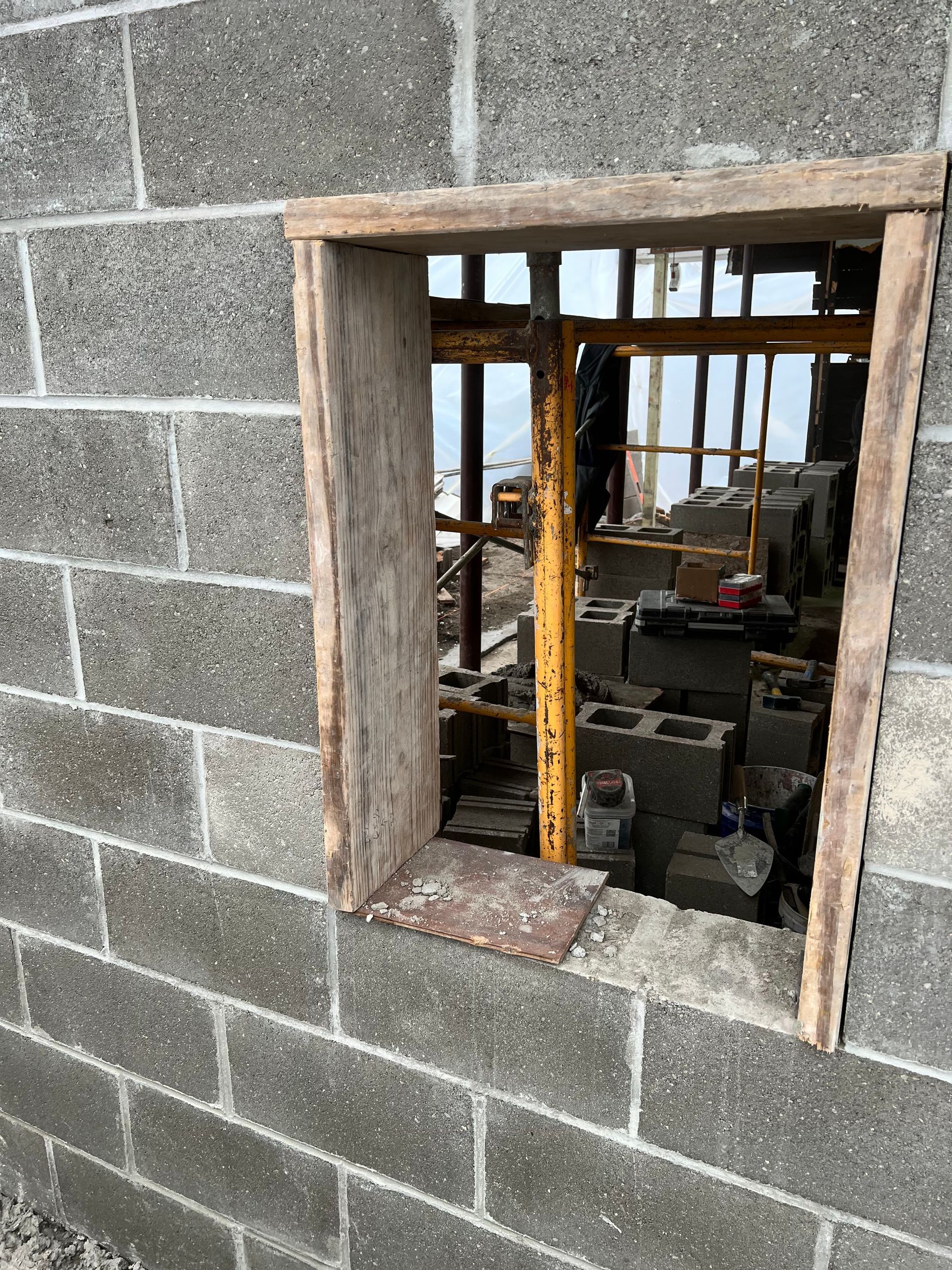 A window in a brick wall with a wooden frame