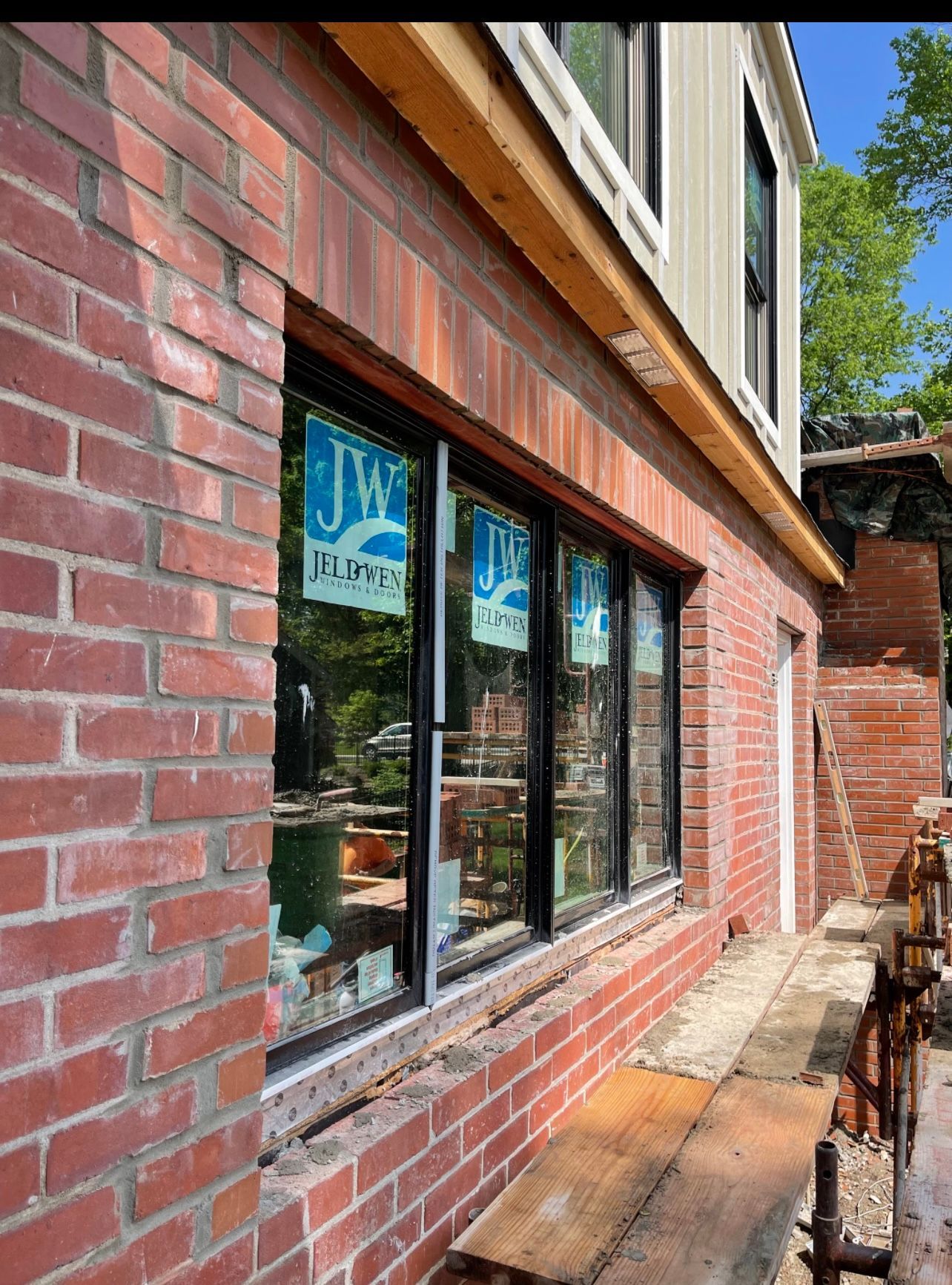 A brick building with a lot of windows is being built.