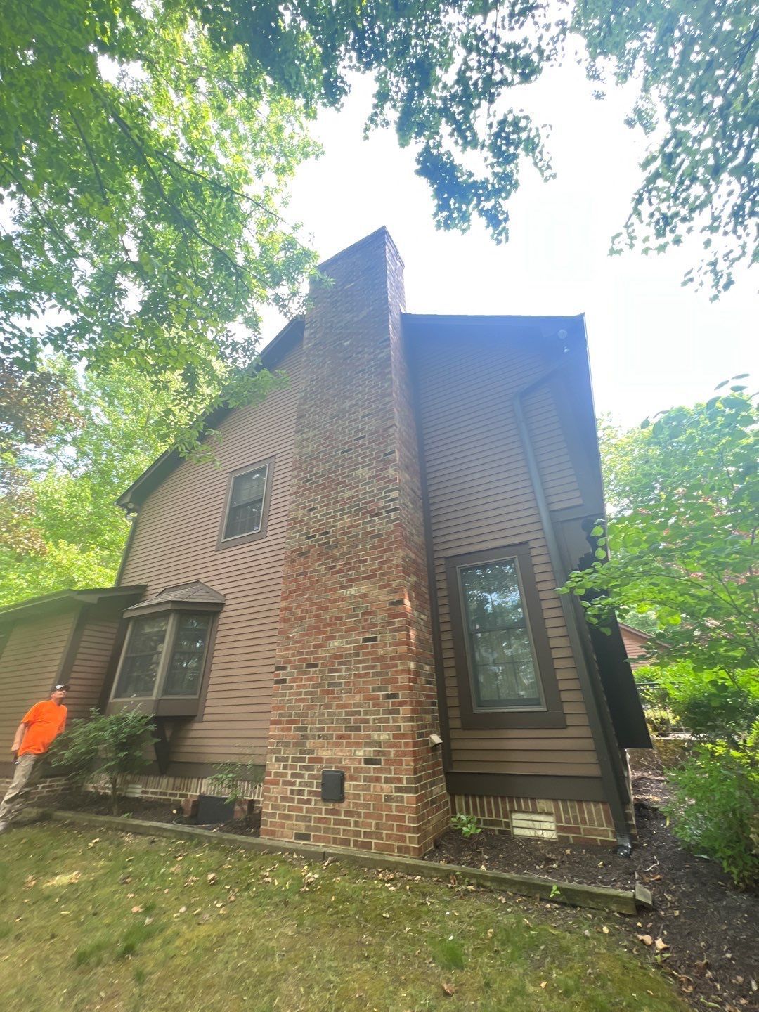 A house with a brick chimney on the side of it