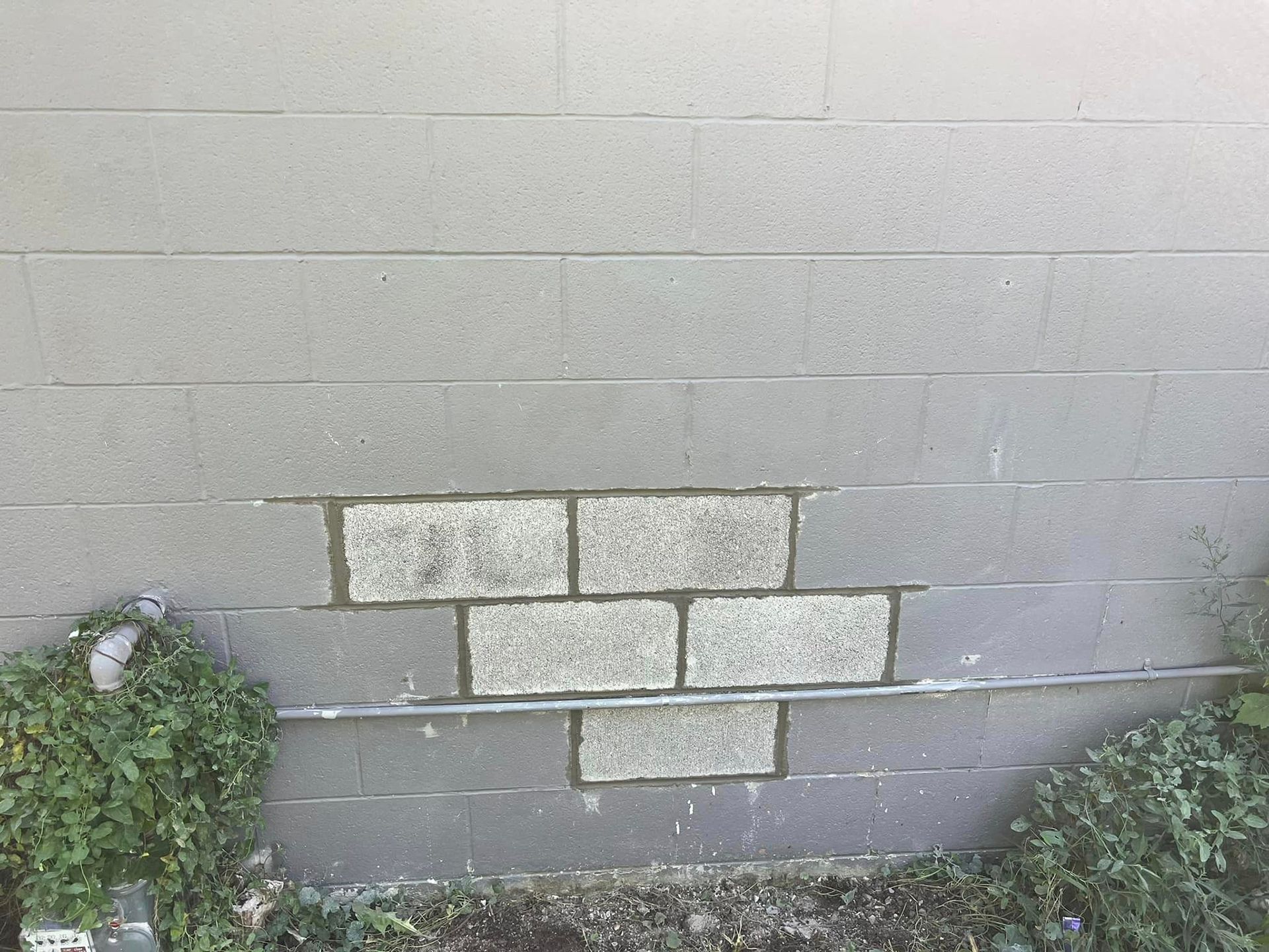 A brick wall with a hole in it that looks like a brick wall.