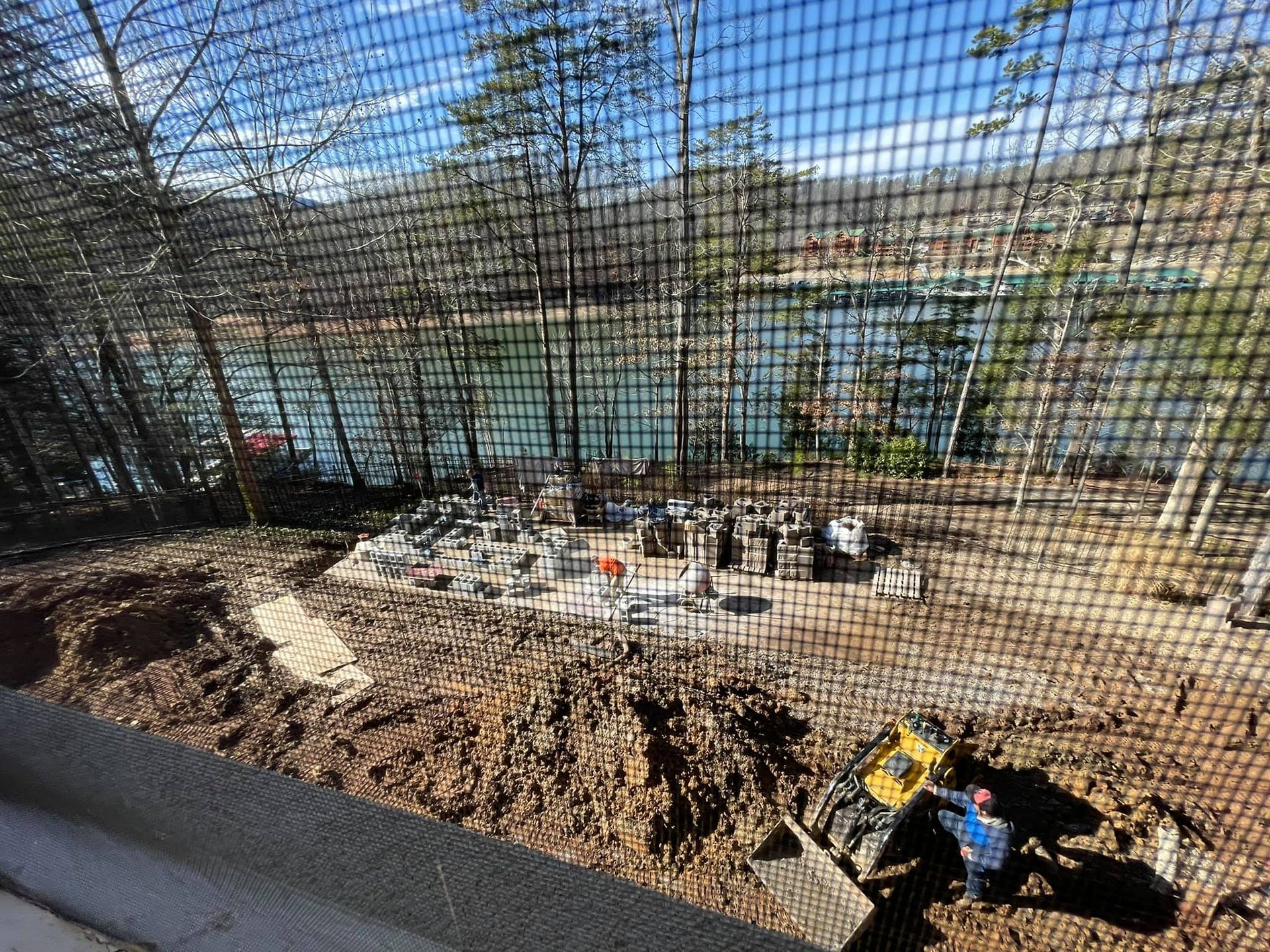 A view of a lake through a screen door.