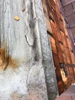 A close up of a piece of wood on a wall.