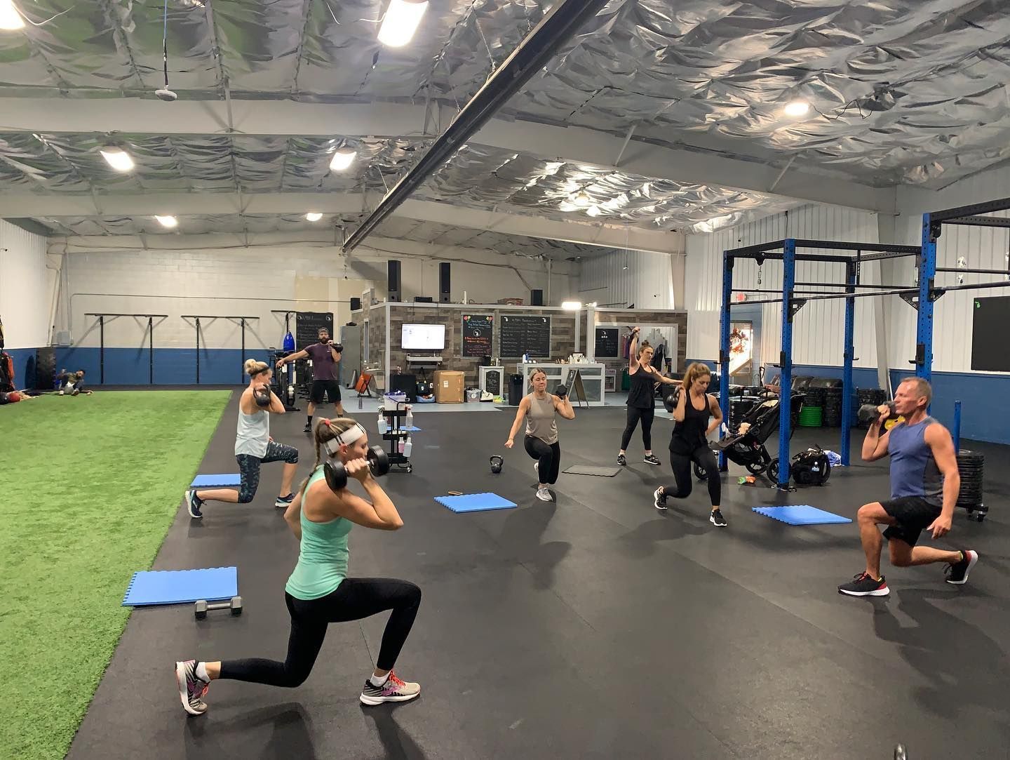 A group of people are doing exercises in a gym.