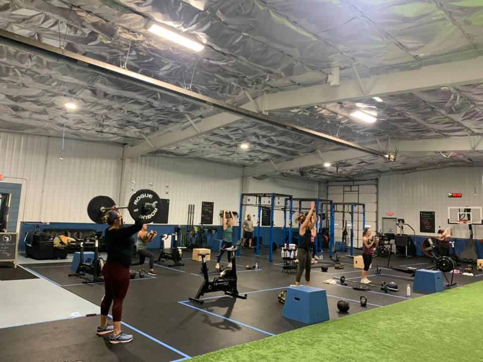 A group of people are doing exercises in a gym.