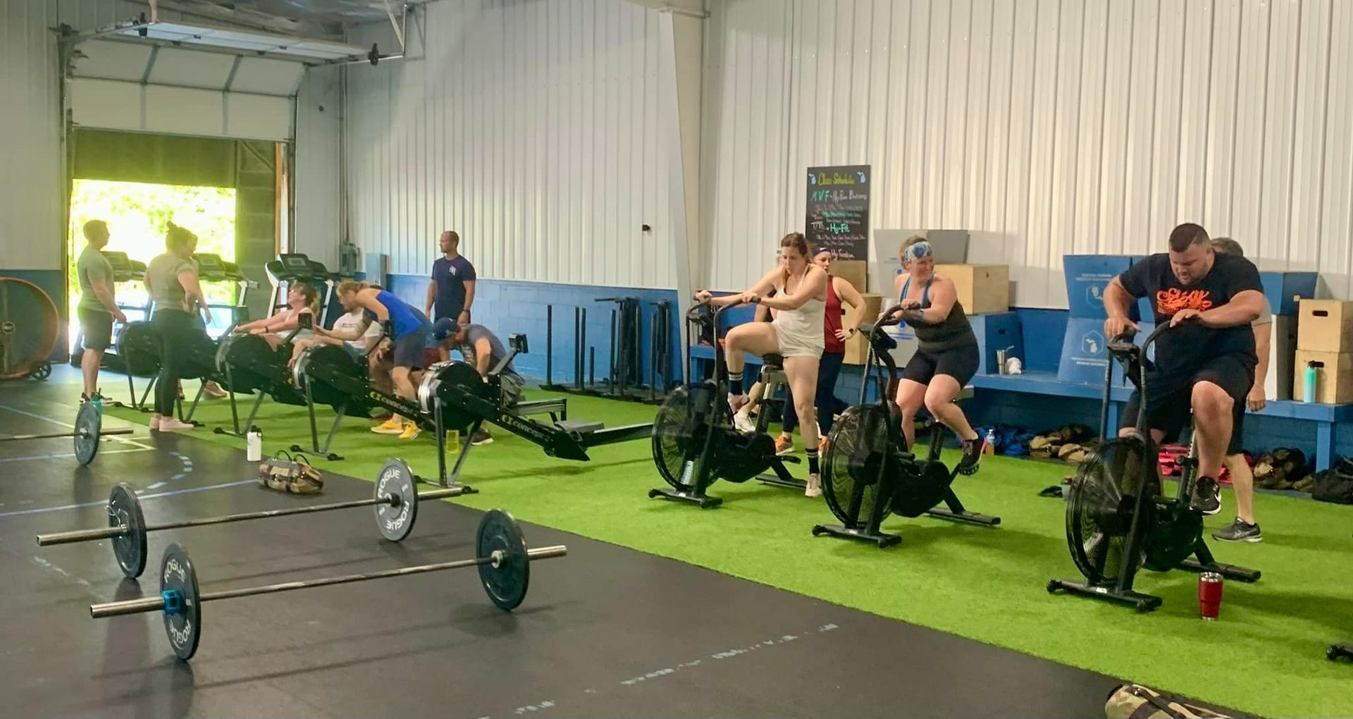 A group of people are riding exercise bikes in a gym.