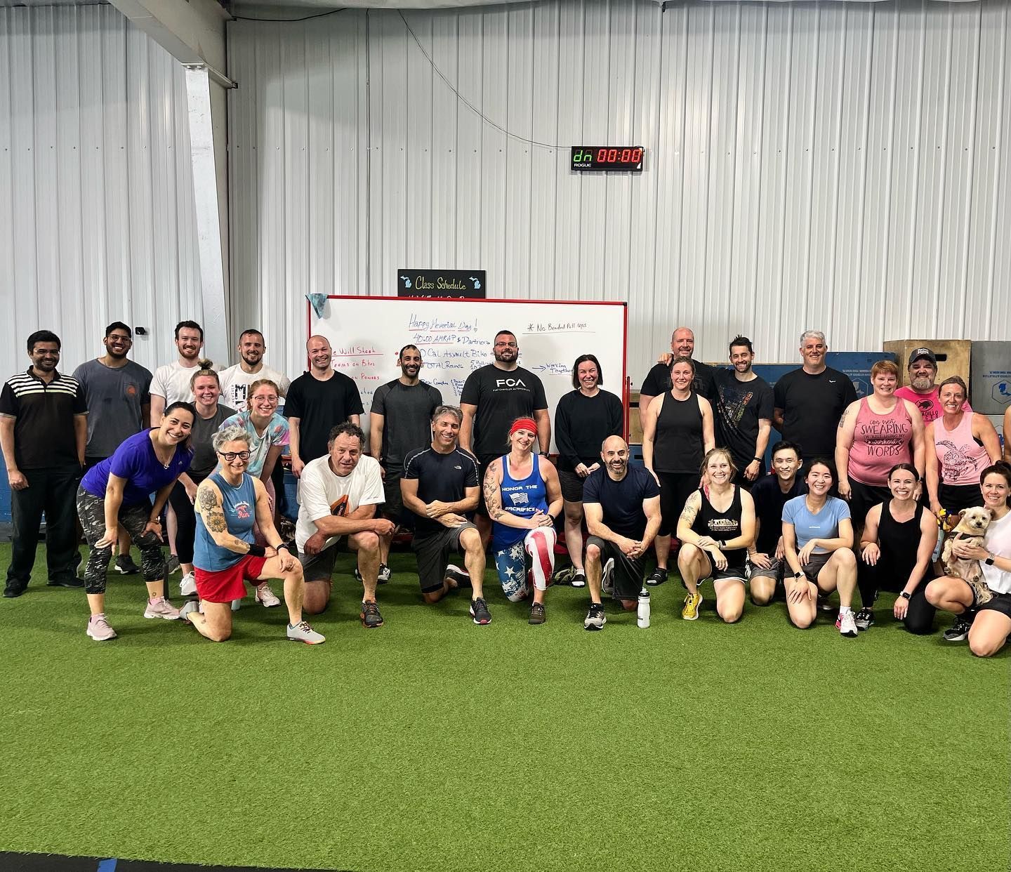 A group of people are posing for a picture in a gym.