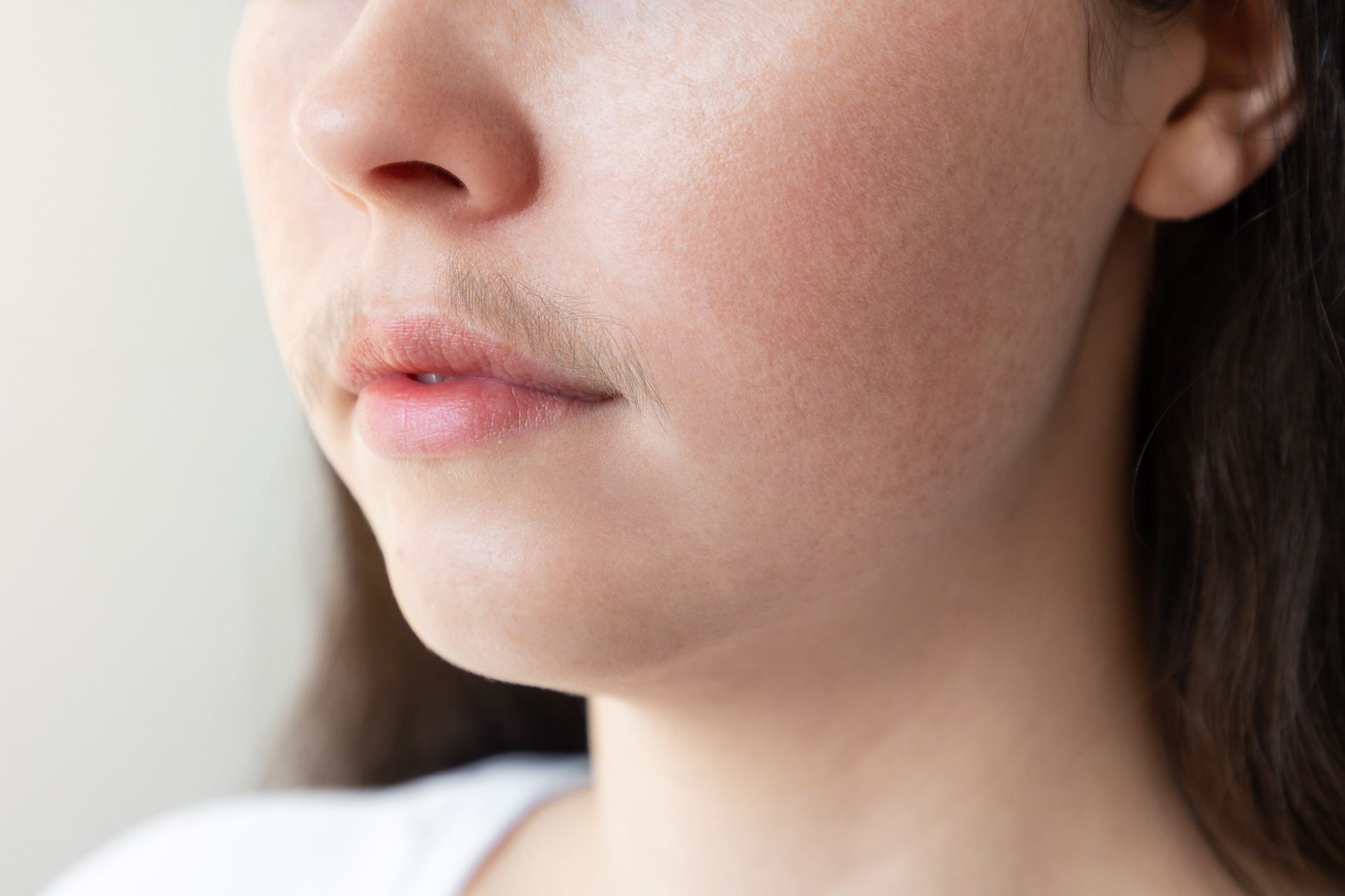 A close up of a woman 's face with a beard.