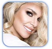 A close up of a woman 's face with blonde hair smiling.