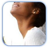 A woman is smiling and looking up at the sky.