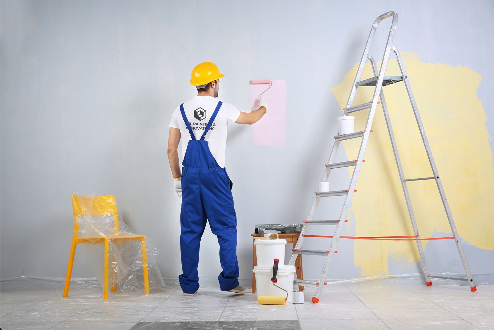 a man is painting a wall next to a ladder .