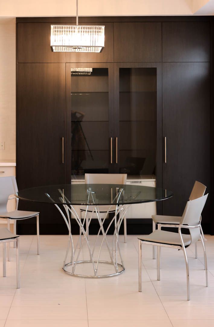a dining room with a glass table and chairs