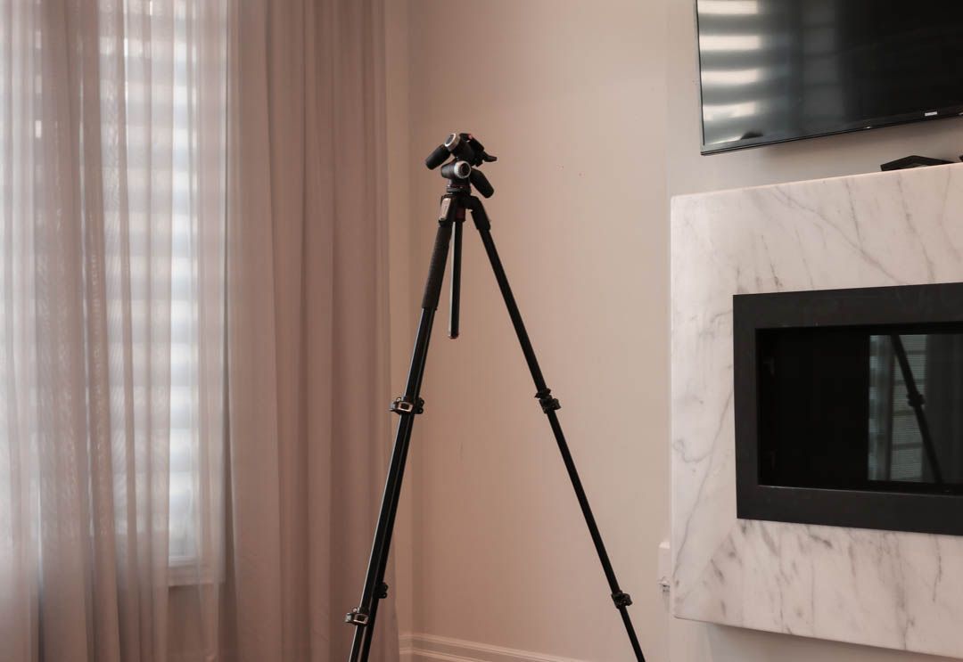 a tripod is sitting in a living room next to a fireplace .