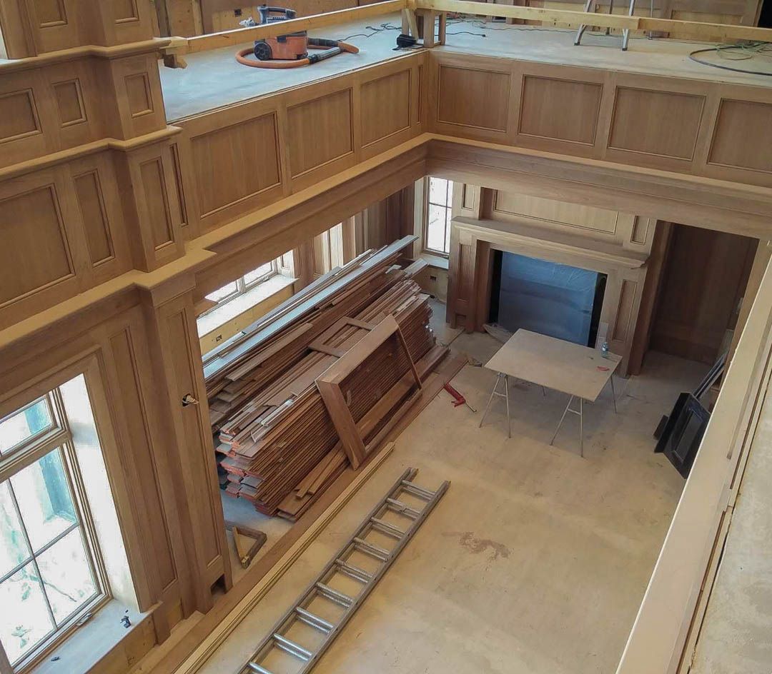 an aerial view of a room with wood paneling and a ladder