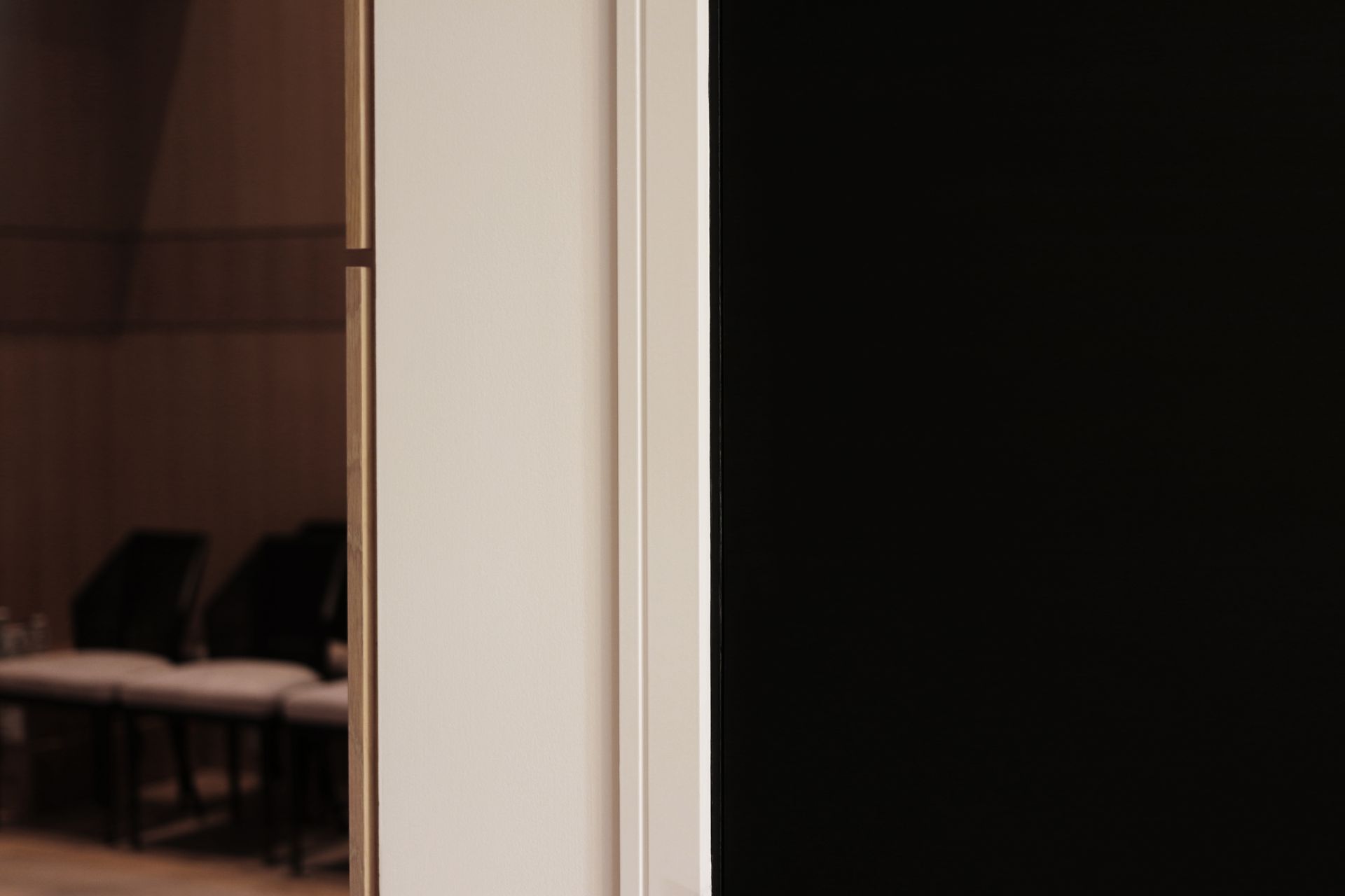 a close up of a door with a reflection of chairs in it .