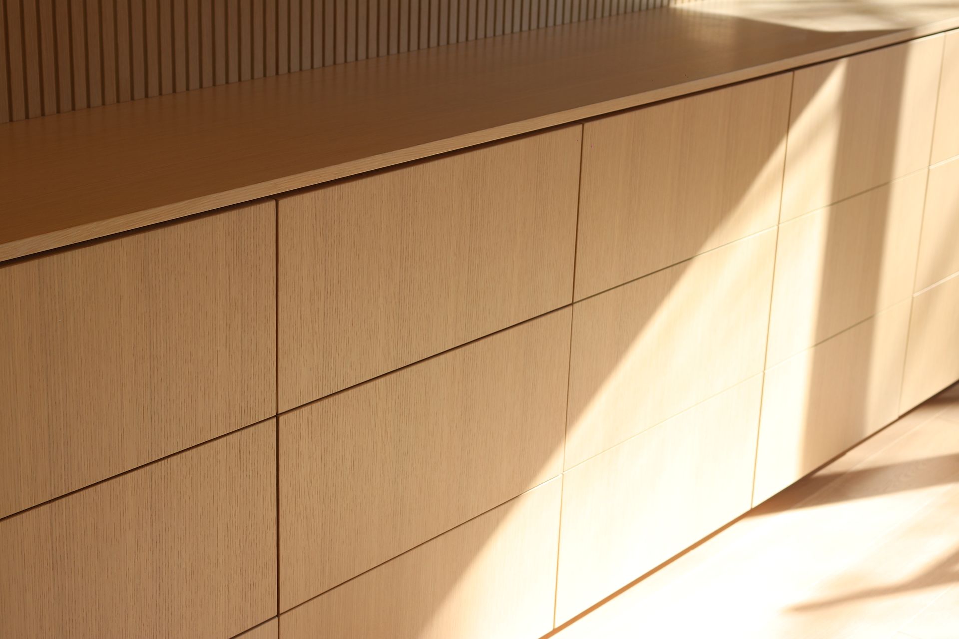 a wooden cabinet with a shadow on the floor