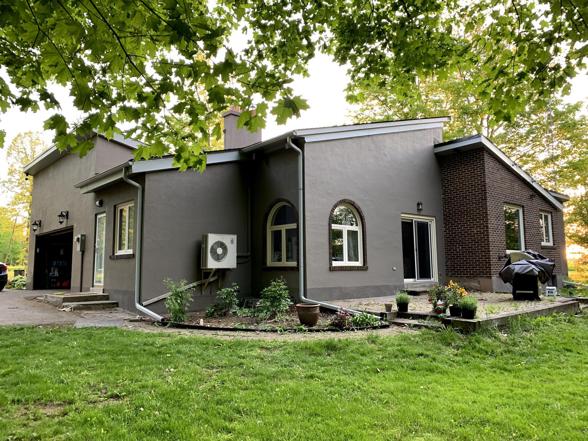 a large house with a lot of windows is sitting on top of a lush green field .