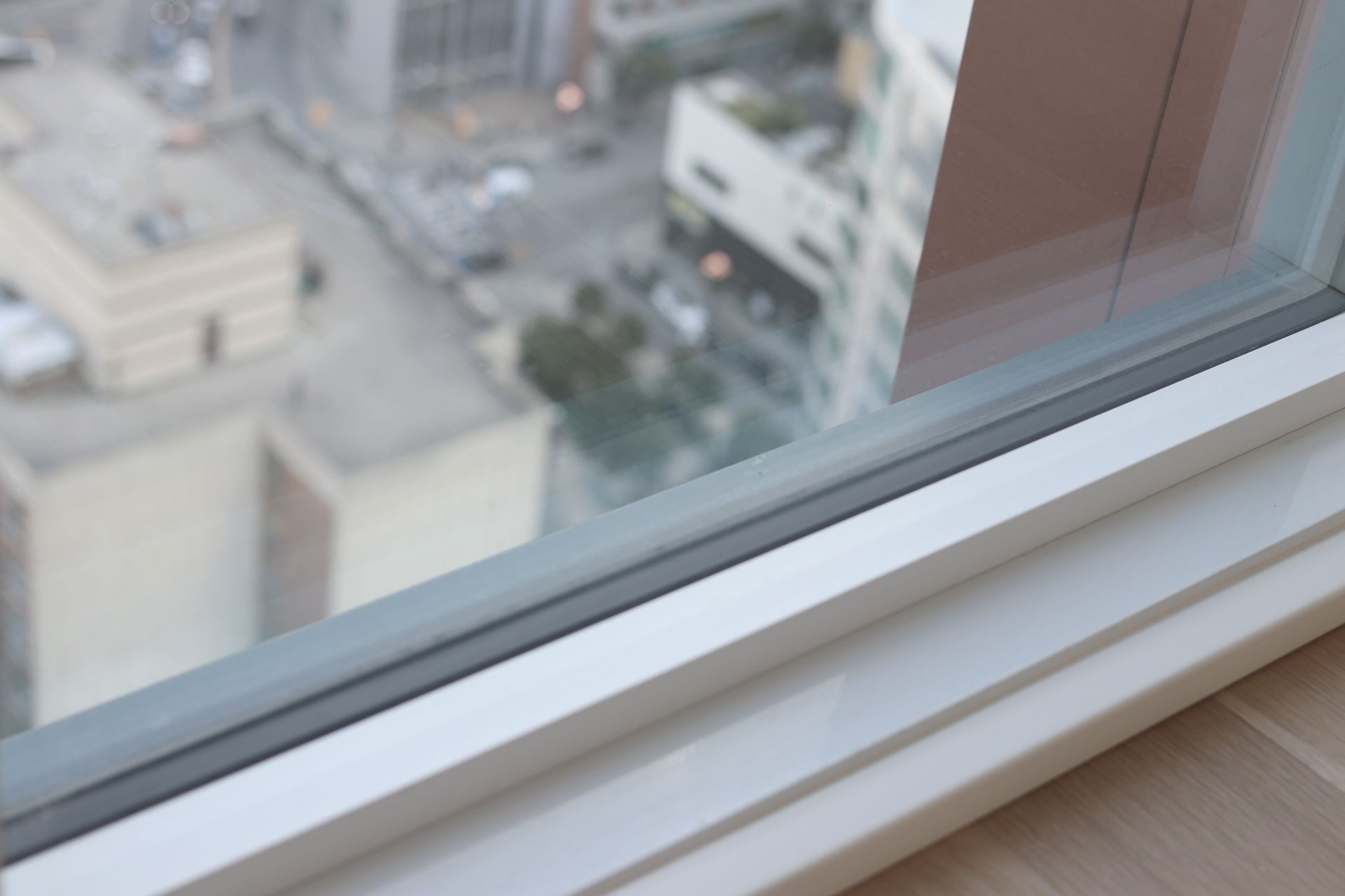 a window with a view of a city in the background